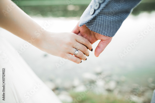 Wedding couple holding hands, groom and bride together on wedding day