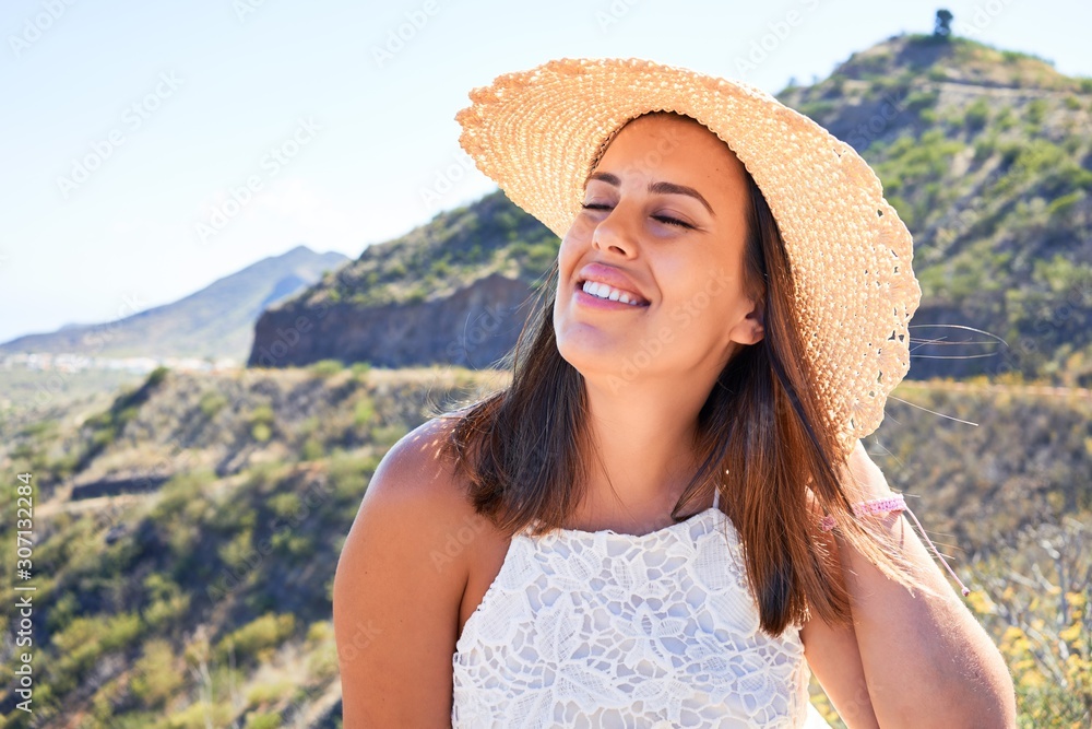 Young beautiful woman enjoying summer vacation on mountain landscape, traveler girl smiling happy