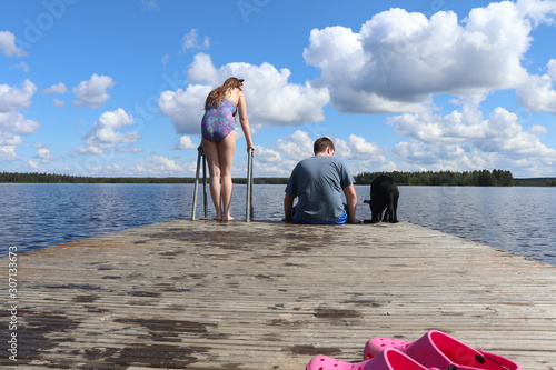 Two teenagers and a dog at Lake Ranuanjarvi in Finland photo