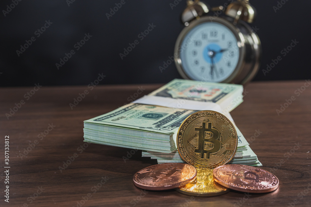 Close up of bitcoin and bank notes on the table