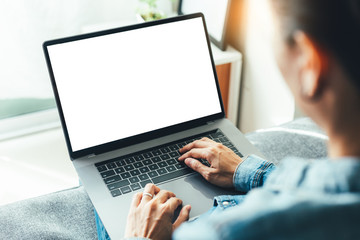 mockup image blank screen computer with blank white background for advertising text,hand man using laptop contact business search information on desk at home office.marketing and creative design