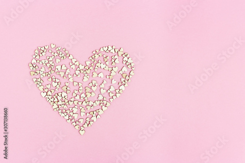 Big heart consists from many small hearts on pink background with copy space for text or congratulations. Love or holiday concept .