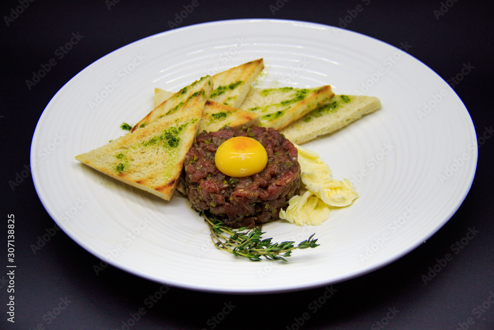 beef tartare with croutons on black background beef tartare with croutons on black background