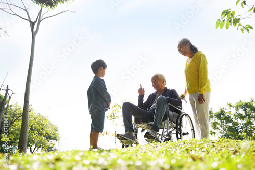 Photography asian grandparents and grandson enjoying nature in park