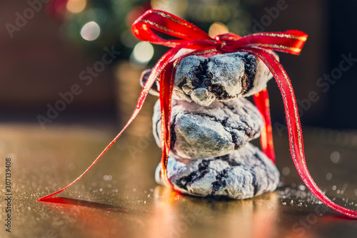 Three Christmas cookies gift on a golden colored table with bokeh lights  close up  macro photography