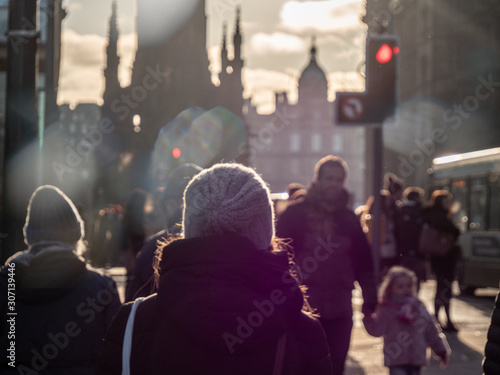 Edinburgh, Scotland - 12/01/2019: Silhouettes and outlines from the streets and alleyways of Edinburgh in Scotland. Sunrays and bokeh effects hit the camera lense as people go about their daily life.