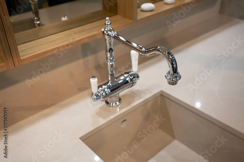 beautiful chromic elegant water tape  with square sink for kitchen of bathroom. photo