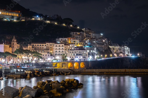 Night view of Amalfi cityscape on coast of mediterranean sea, Italy.