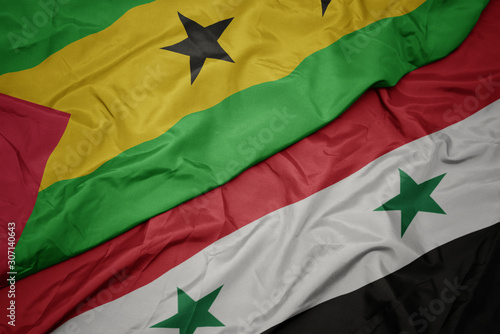 waving colorful flag of syria and national flag of sao tome and principe .