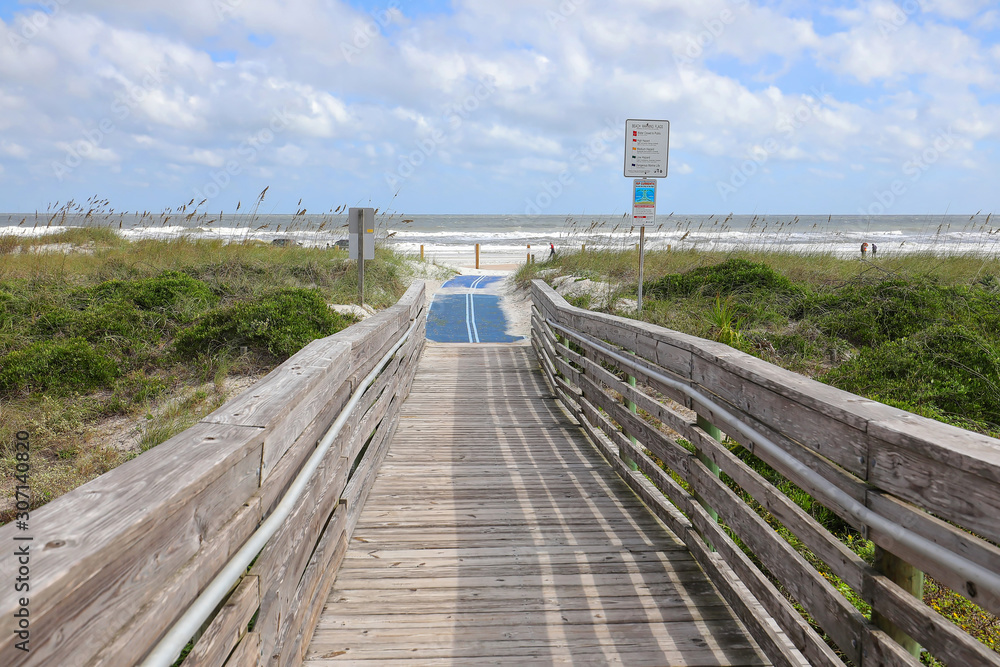 Blue roll out mat for handicapped beach access to Amelia Beach, Florida, USA.
