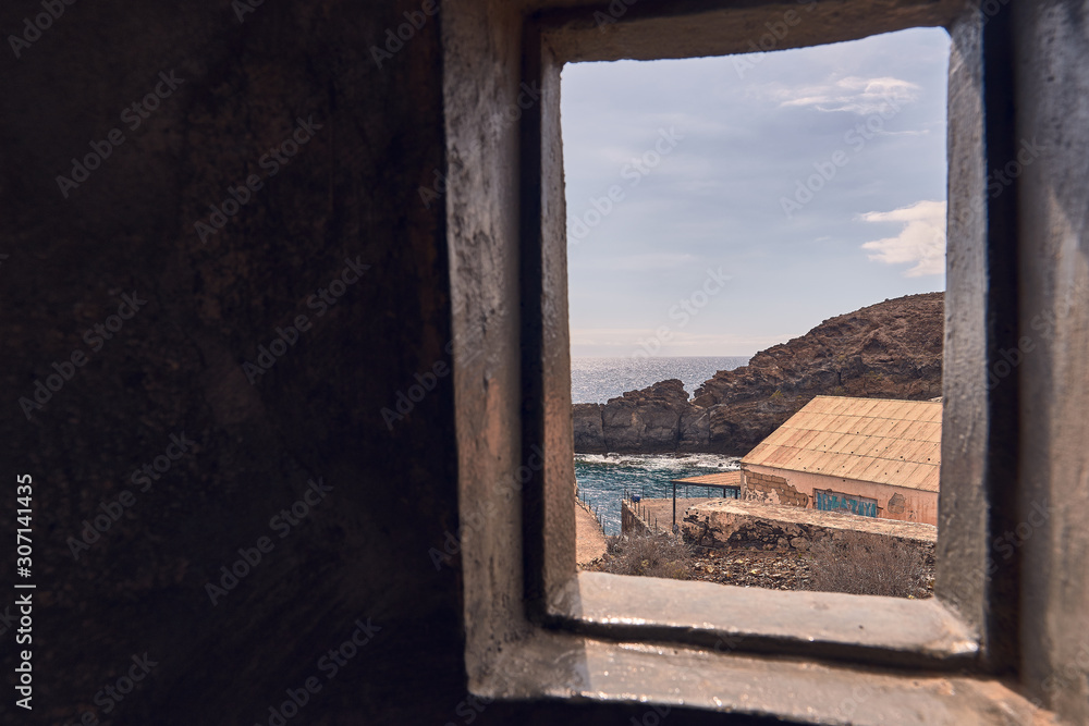 Window overlooking the sea from inside a marine lighthouse in Tenerife, Canary Islands, Spain