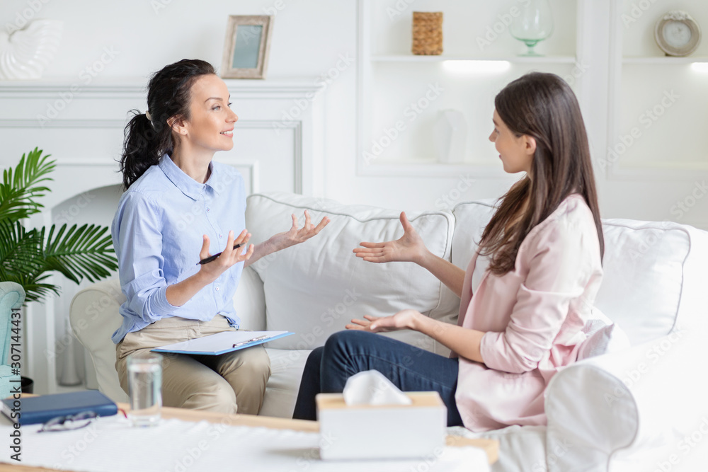 Female patient and psychotherapist having positive inspiring conversation Female patient and psychotherapist having positive inspiring conversation