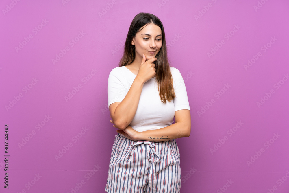 Young woman over isolated purple background looking to the side Young woman over isolated purple background looking to the side