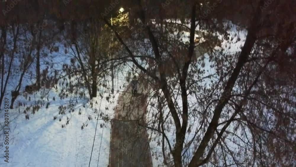 Aerial video shot. Drone flies over the trees in park. Snowy winter in Russian forest. Aerial video shot. Drone flies over the trees in park. Snowy winter in Russian forest.