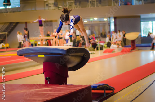 Young gymnast girl performing jump