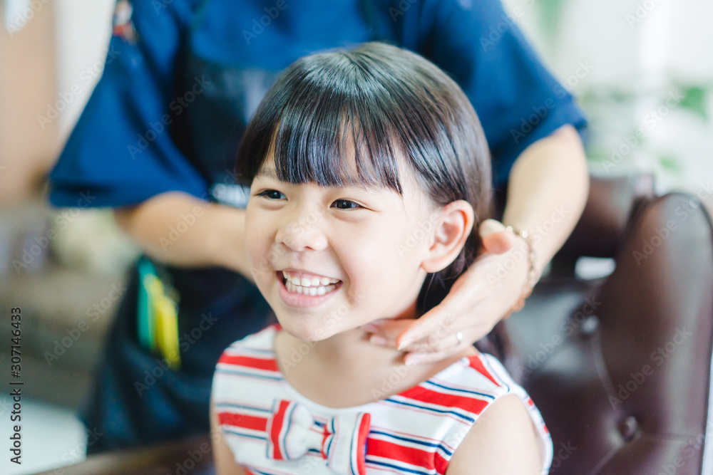 Asian little girl haircut. hairdresser, beauty salon.Cute little asian