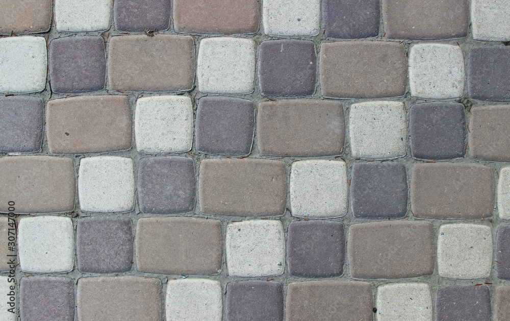 Texture of pavement made of paving tiles of three colors with cement between tiles Texture of pavement made of paving tiles of three colors with cement between tiles