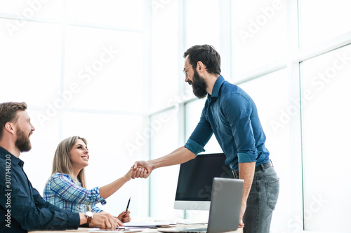 Manager meets the client,holding out his hand for a handshake