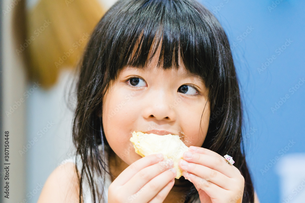 5 years old girl.Little asian thai girl eating durian fruit at home.She make every happy and yummy face.First time with durian.Durians are the king of fruits. 5 years old girl.Little asian thai girl eating durian fruit at home.She make every happy and yummy face.First time with durian.Durians are the king of fruits.