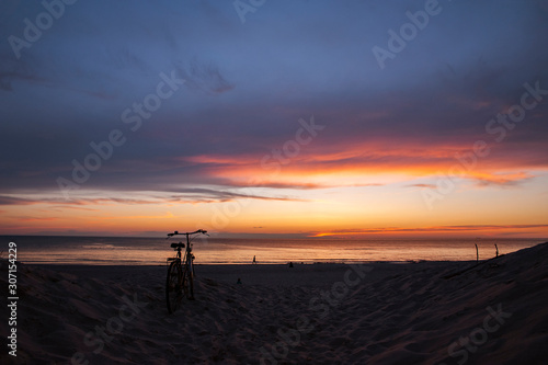 Bicycle on the beach at sunset