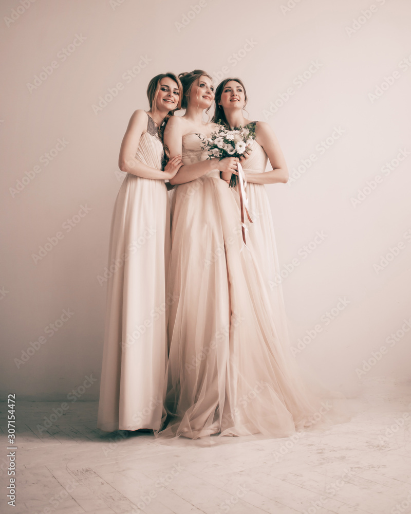 in full growth.three beautiful girls in dresses for the wedding ceremony.