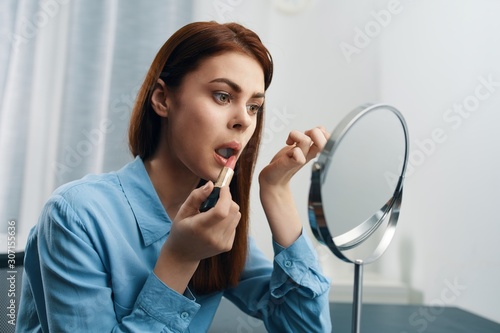 young woman applying make up
