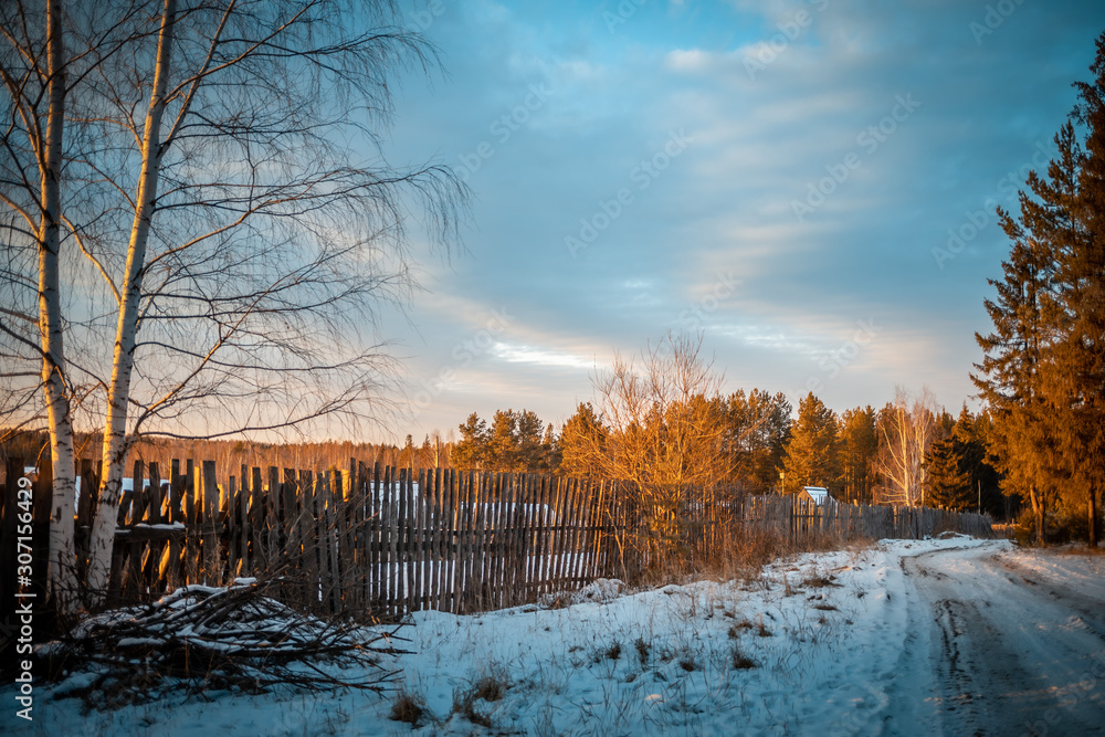 sunset in the village winter in the forest landscape russia