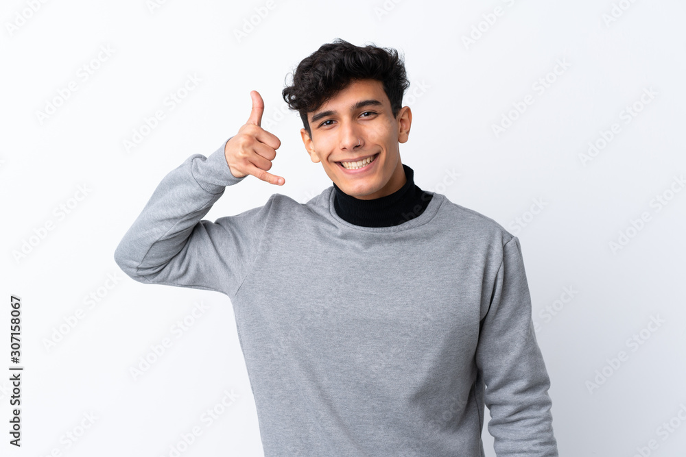 Young Argentinian man over isolated white background making phone gesture. Call me back sign Young Argentinian man over isolated white background making phone gesture. Call me back sign