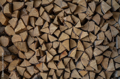 woodpile of dry chopped birch firewood. rough surface texture