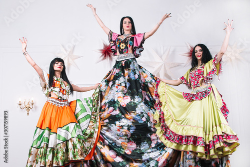 three female dancers in traditional Gypsy dresses