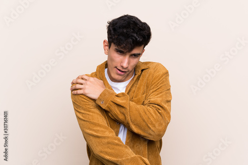 Young Argentinian man over isolated background suffering from pain in shoulder for having made an effort