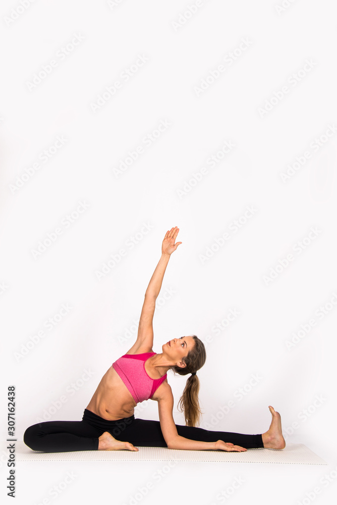 Girl practicing yoga poses, yoga female instructor. Isolated on white, indoor photo