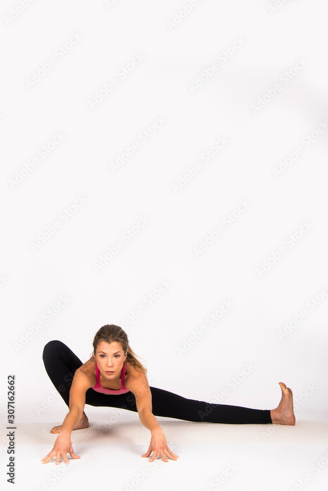 Girl practicing yoga poses, yoga female instructor. Isolated on white, indoor photo Girl practicing yoga poses, yoga female instructor. Isolated on white, indoor photo