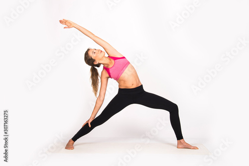 Girl practicing yoga poses, yoga female instructor. Isolated on white, indoor photo
