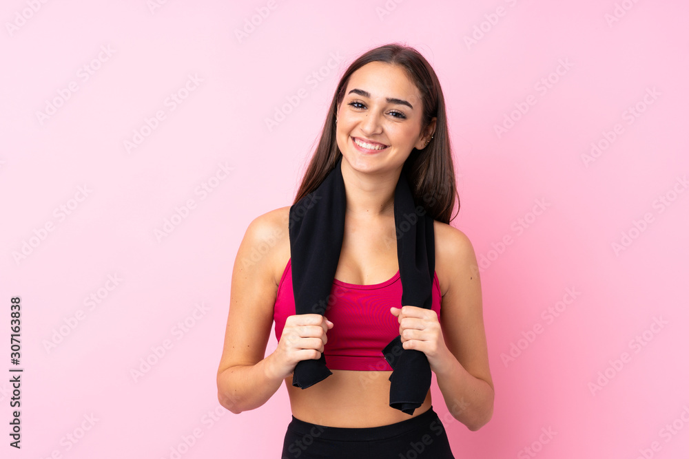 Young sport girl over isolated pink background with sport towel Young sport girl over isolated pink background with sport towel