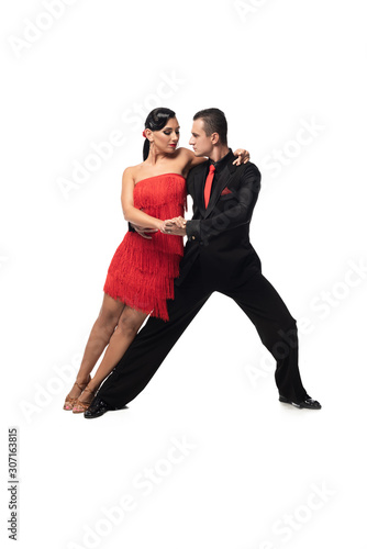 elegant couple of dancers performing tango on white background