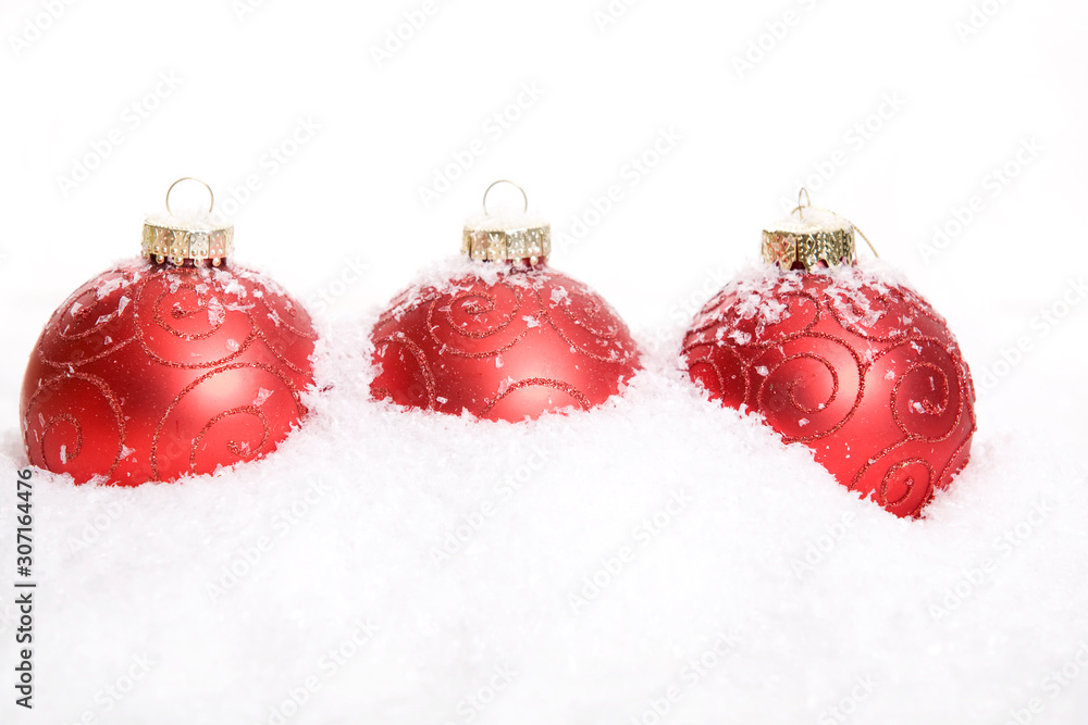 Red Christmas Baubles in snow Red Christmas Baubles in snow