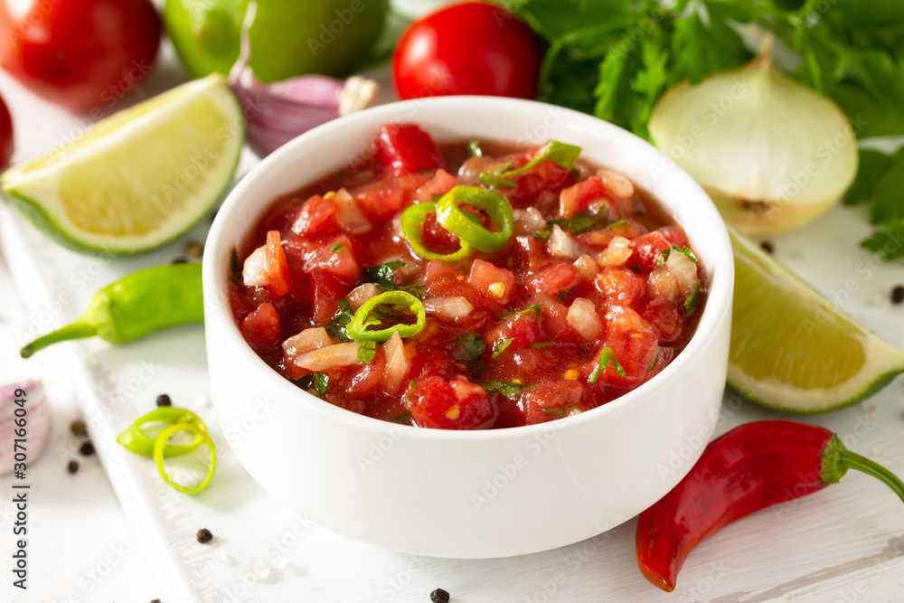 Traditional mexican homemade salsa sauce and ingredients on a white wooden table. - obrazy, fototapety, plakaty 