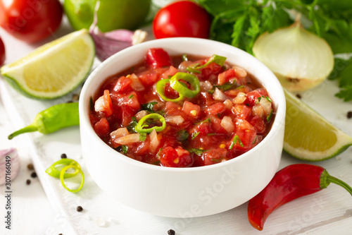 Fotografie Traditional mexican homemade salsa sauce and ingredients on a white wooden table