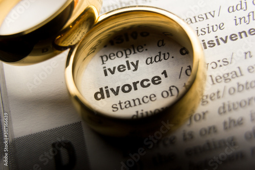 Divorce and separation concept. Two golden wedding rings. Dictionary definition