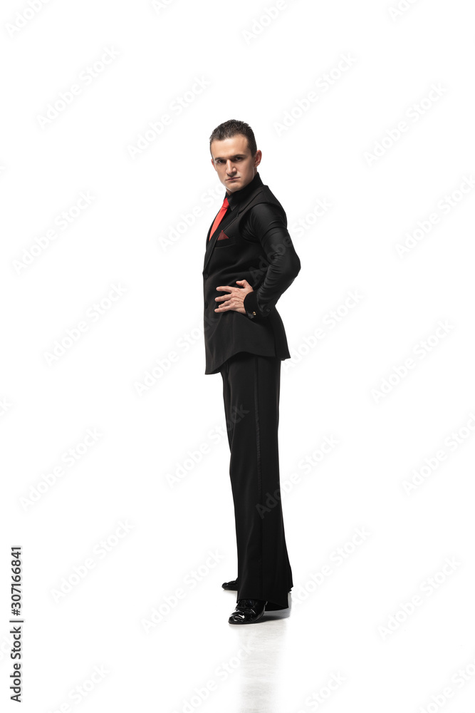 confident, elegant tango dancer looking at camera while standing with hand on hip on white background confident, elegant tango dancer looking at camera while standing with hand on hip on white background