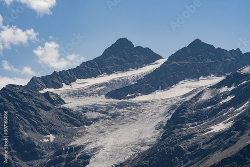 snow-covered mountain with a glacier, a rocky peak in the afternoon. Caucasus, Russia