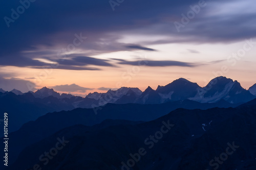 Dawn in the mountains. Old high  sharp mountain peaks on the background of the dawn. The Caucasus.