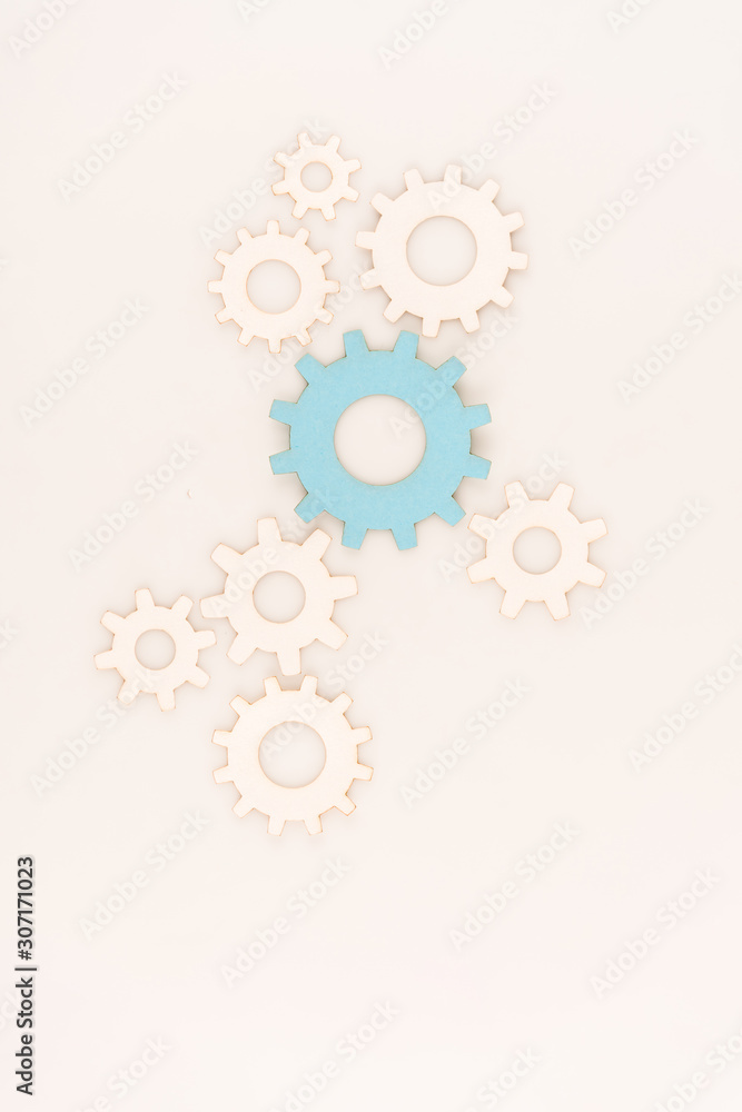 top view of one blue gear among another isolated on white