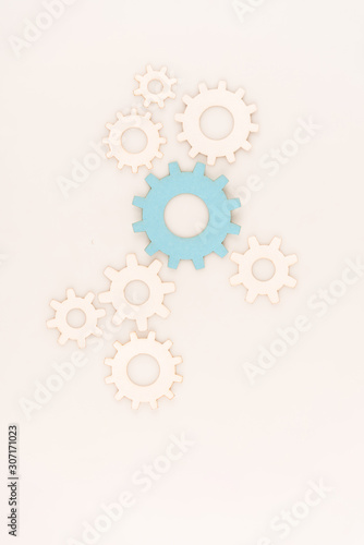 top view of one blue gear among another isolated on white