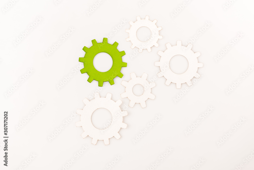top view of one green gear among another isolated on white top view of one green gear among another isolated on white