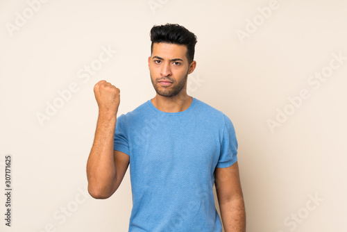 Young handsome man over isolated background with angry gesture