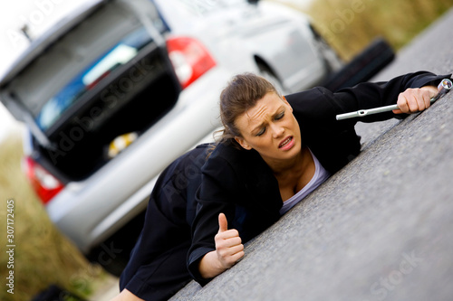 Woman in despair her broken down car