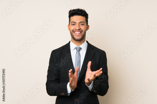 Young handsome businessman man over isolated background applauding