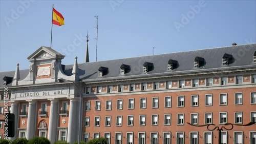 Tilt up shot of the air force headquarters of Spain in Madrid with the spanish flag on the top. photo